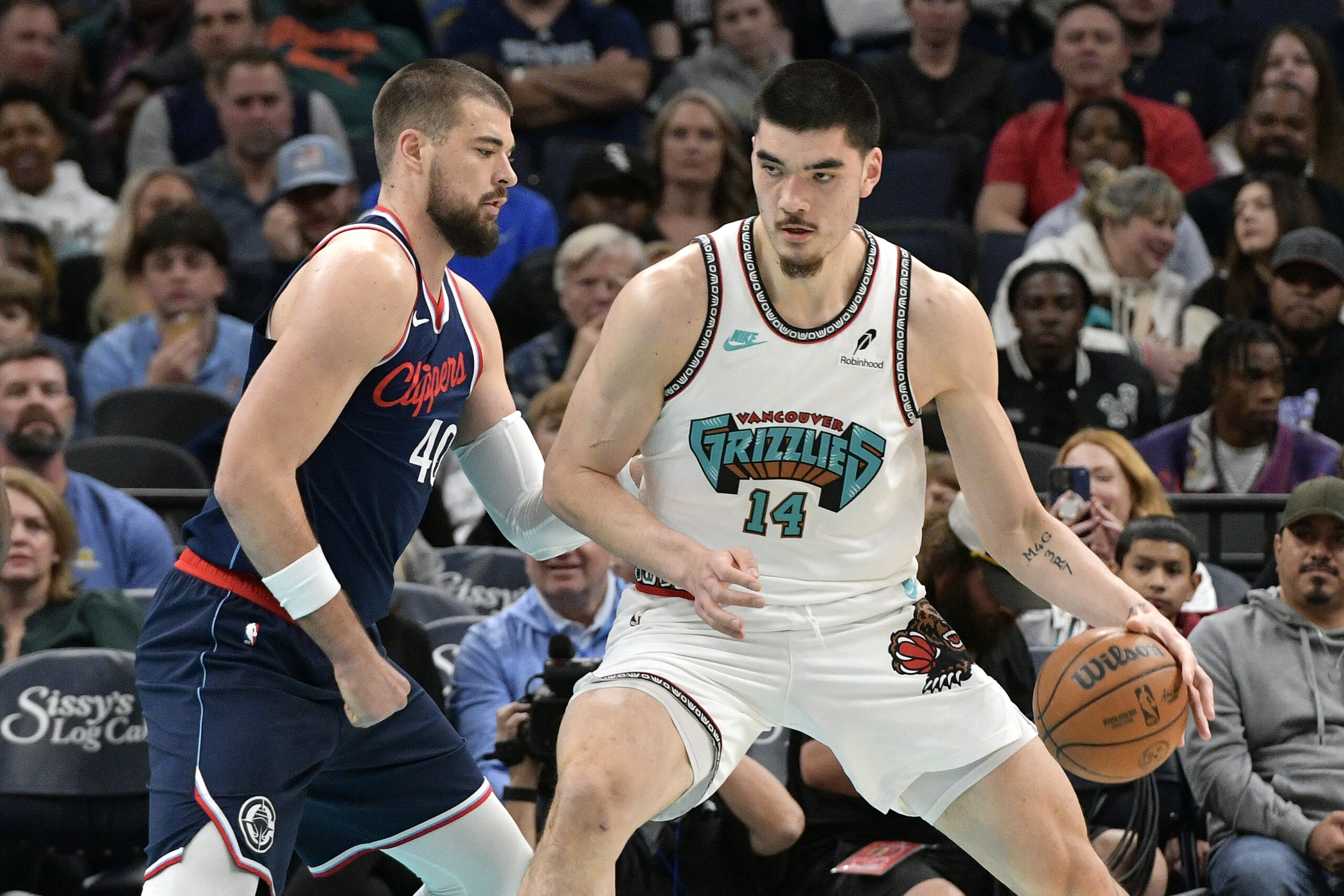 Memphis Grizzlies center Zach Edey (14) handles the ball against Los Angeles Clippers center Ivica Zubac (40) in the first half of an NBA basketball game Monday, Dec. 23, 2024, in Memphis, Tenn. (AP Photo/Brandon Dill)