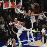 San Antonio Spurs' Victor Wembanyama (1), top right, commits goaltending on a shot put up by New York Knicks' Josh Hart (3), top left, during the first half of an NBA basketball game, Wednesday, Dec. 25, 2024, in New York. (AP Photo/Seth Wenig)