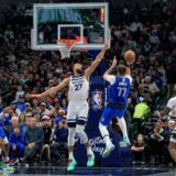 Dallas Mavericks guard Luka Doncic (77) attempts a shot over Minnesota Timberwolves center Rudy Gobert (27) in the first half of an NBA basketball game on Wednesday, Dec. 25, 2024, in Dallas. (AP Photo/Emil T. Lippe) Timberwolves Mavericks Basketball