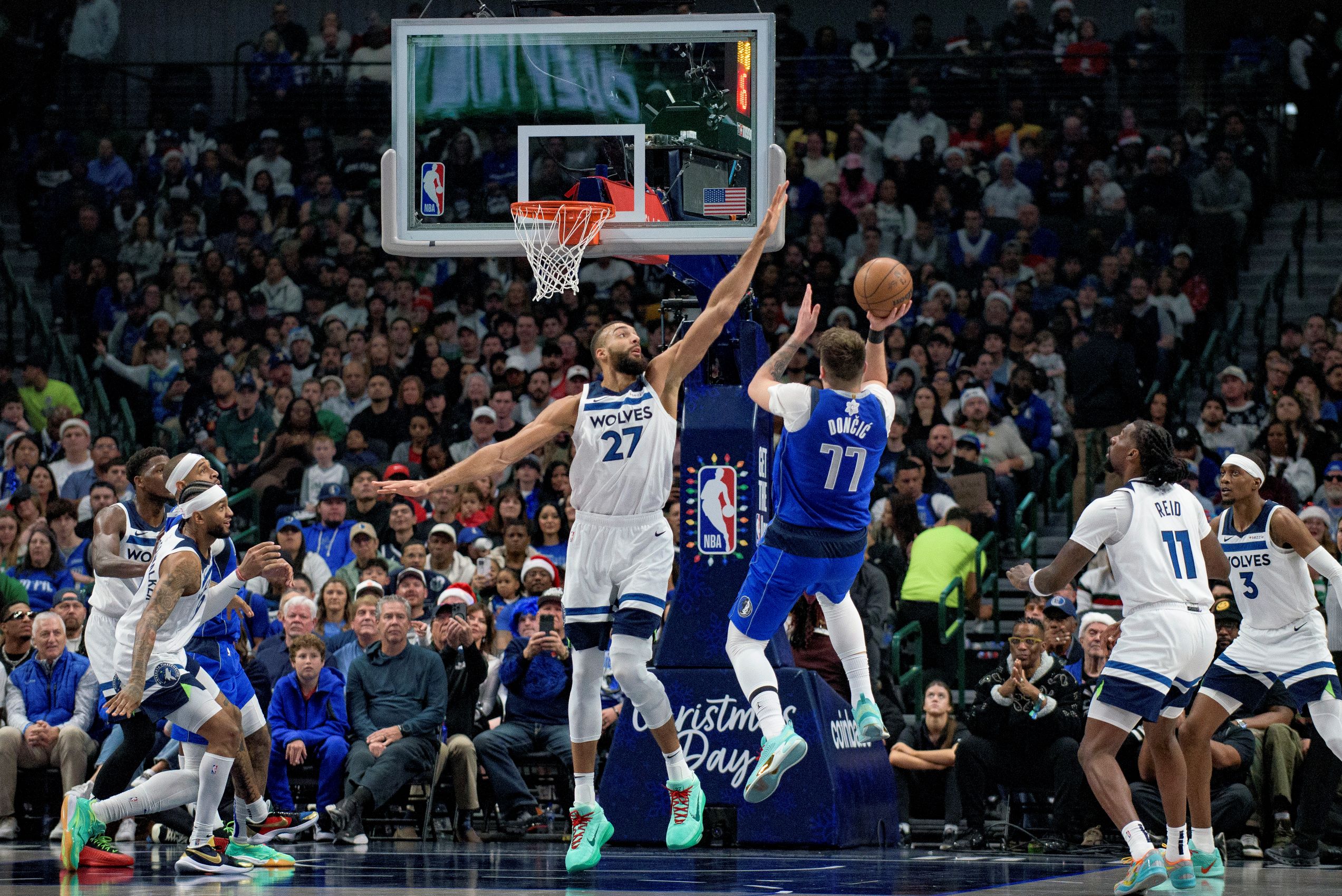 Dallas Mavericks guard Luka Doncic (77) attempts a shot over Minnesota Timberwolves center Rudy Gobert (27) in the first half of an NBA basketball game on Wednesday, Dec. 25, 2024, in Dallas. (AP Photo/Emil T. Lippe) Timberwolves Mavericks Basketball