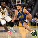 Golden State Warriors guard Stephen Curry (30) dribbles against Los Angeles Lakers forward LeBron James (23) during the second half of an NBA basketball game Wednesday, Dec. 25, 2024, in San Francisco. (AP Photo/Eakin Howard) Lakers Warriors Basketball