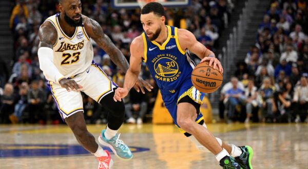 Golden State Warriors guard Stephen Curry (30) dribbles against Los Angeles Lakers forward LeBron James (23) during the second half of an NBA basketball game Wednesday, Dec. 25, 2024, in San Francisco. (AP Photo/Eakin Howard) Lakers Warriors Basketball