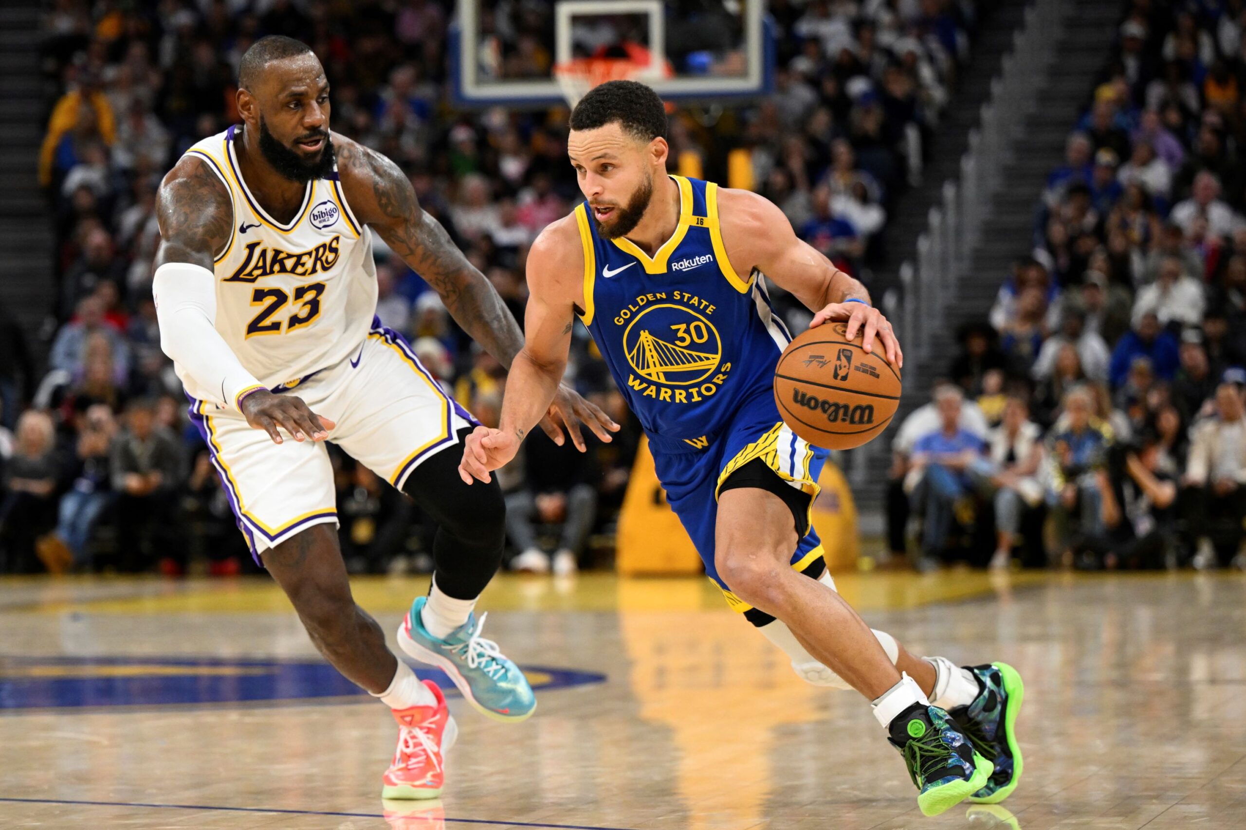 Golden State Warriors guard Stephen Curry (30) dribbles against Los Angeles Lakers forward LeBron James (23) during the second half of an NBA basketball game Wednesday, Dec. 25, 2024, in San Francisco. (AP Photo/Eakin Howard) Lakers Warriors Basketball