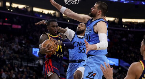 Golden State Warriors guard Dennis Schroder, left, drives against Los Angeles Clippers forward Derrick Jones Jr., center, and center Ivica Zubac during the first half of an NBA basketball game Friday, Dec. 27, 2024, in Inglewood, Calif. (AP Photo/Ryan Sun) Warriors Clippers Basketball