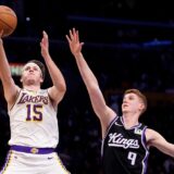 Los Angeles Lakers guard Austin Reaves, left, shoots as Sacramento Kings guard Kevin Huerter defends during the first half of an NBA basketball game, Saturday, Dec. 28, 2024, in Los Angeles. (AP Photo/Mark J. Terrill) Kings Lakers Basketball