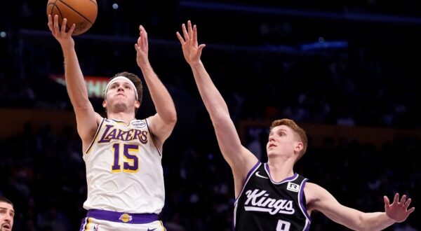 Los Angeles Lakers guard Austin Reaves, left, shoots as Sacramento Kings guard Kevin Huerter defends during the first half of an NBA basketball game, Saturday, Dec. 28, 2024, in Los Angeles. (AP Photo/Mark J. Terrill) Kings Lakers Basketball