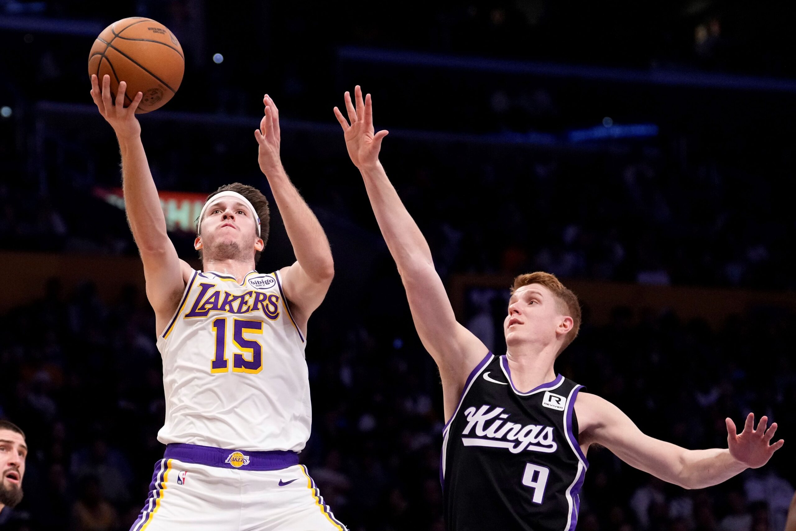 Los Angeles Lakers guard Austin Reaves, left, shoots as Sacramento Kings guard Kevin Huerter defends during the first half of an NBA basketball game, Saturday, Dec. 28, 2024, in Los Angeles. (AP Photo/Mark J. Terrill) Kings Lakers Basketball