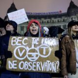 epa11748603 Romanian protesters shout slogans and hold up placards while braving the rain during a protest at the University Plaza, against far-right independent presidential candidate Calin Georgescu, in central Bucharest, Romania, 29 November 2024. Students and civil rights activists continue their protests against the far-right independent runoff candidate Calin Georgescu, whose declarations worried human right activists. Romania's Constitutional Court (CCR) on 28 November instructed the Central Electoral Bureau (BEC) to recount all ballots from the first round of presidential elections held on 24 November, following complaints from two candidates. On 29 November the court announced that the final decision had been postponed until 02 December, the day after the Parliamentary elections. The placard reads: 'BEC, ARE YOU AFRAID OF OBSERVERS?'.  EPA/ROBERT GHEMENT