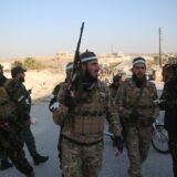 epa11750162 Opposition fighters patrol the streets after they took control of the city of Maarat al-Numan where the international road M5 passes through it, in Maarat al-Numan, Syria, 30 November 2024, following a large offensive by rebel forces November 27, taking large parts of the country's second-biggest city. The offensive triggered Russian strikes on Aleppo 30 November 2024, the first since 2016, and saw Syria's military withdraw its troops from the city. The attack was led by the Islamist militant group Hayat Tahrir al-Sham (HTS).  EPA/BILAL AL HAMMOUD