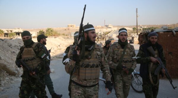 epa11750162 Opposition fighters patrol the streets after they took control of the city of Maarat al-Numan where the international road M5 passes through it, in Maarat al-Numan, Syria, 30 November 2024, following a large offensive by rebel forces November 27, taking large parts of the country's second-biggest city. The offensive triggered Russian strikes on Aleppo 30 November 2024, the first since 2016, and saw Syria's military withdraw its troops from the city. The attack was led by the Islamist militant group Hayat Tahrir al-Sham (HTS).  EPA/BILAL AL HAMMOUD