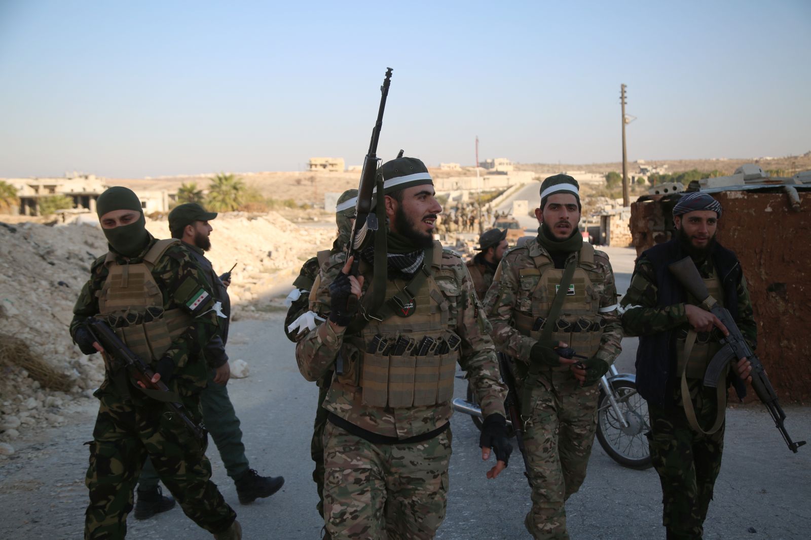 epa11750162 Opposition fighters patrol the streets after they took control of the city of Maarat al-Numan where the international road M5 passes through it, in Maarat al-Numan, Syria, 30 November 2024, following a large offensive by rebel forces November 27, taking large parts of the country's second-biggest city. The offensive triggered Russian strikes on Aleppo 30 November 2024, the first since 2016, and saw Syria's military withdraw its troops from the city. The attack was led by the Islamist militant group Hayat Tahrir al-Sham (HTS).  EPA/BILAL AL HAMMOUD