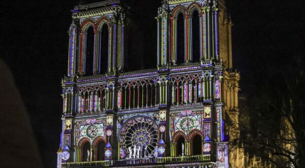 epa11760943 A projection illuminates the front of the Notre Dame cathedral during the final preparations for the reopening of the Notre Dame de Paris cathedral, in Paris, France, 06 December 2024. Paris' Notre-Dame Cathedral will be officially inaugurated on 07 December after nearly six years of renovation work.  EPA/TERESA SUAREZ