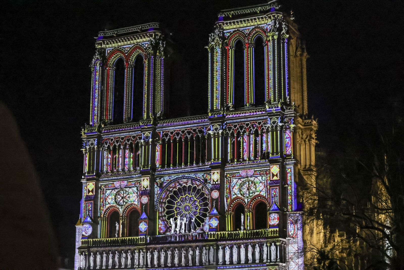 epa11760943 A projection illuminates the front of the Notre Dame cathedral during the final preparations for the reopening of the Notre Dame de Paris cathedral, in Paris, France, 06 December 2024. Paris' Notre-Dame Cathedral will be officially inaugurated on 07 December after nearly six years of renovation work.  EPA/TERESA SUAREZ