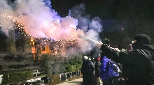 epa11761055 A supporter of the Georgian opposition launches fireworks during a protest in front of the Parliament building in Tbilisi, Georgia, 06 December 2024. Thousands of pro-EU activists continue their protests in the Georgian capital against the country's ruling party decision to suspend accession talks with the European Union (EU) until the end of 2028.  EPA/DAVID MDZINARISHVILI