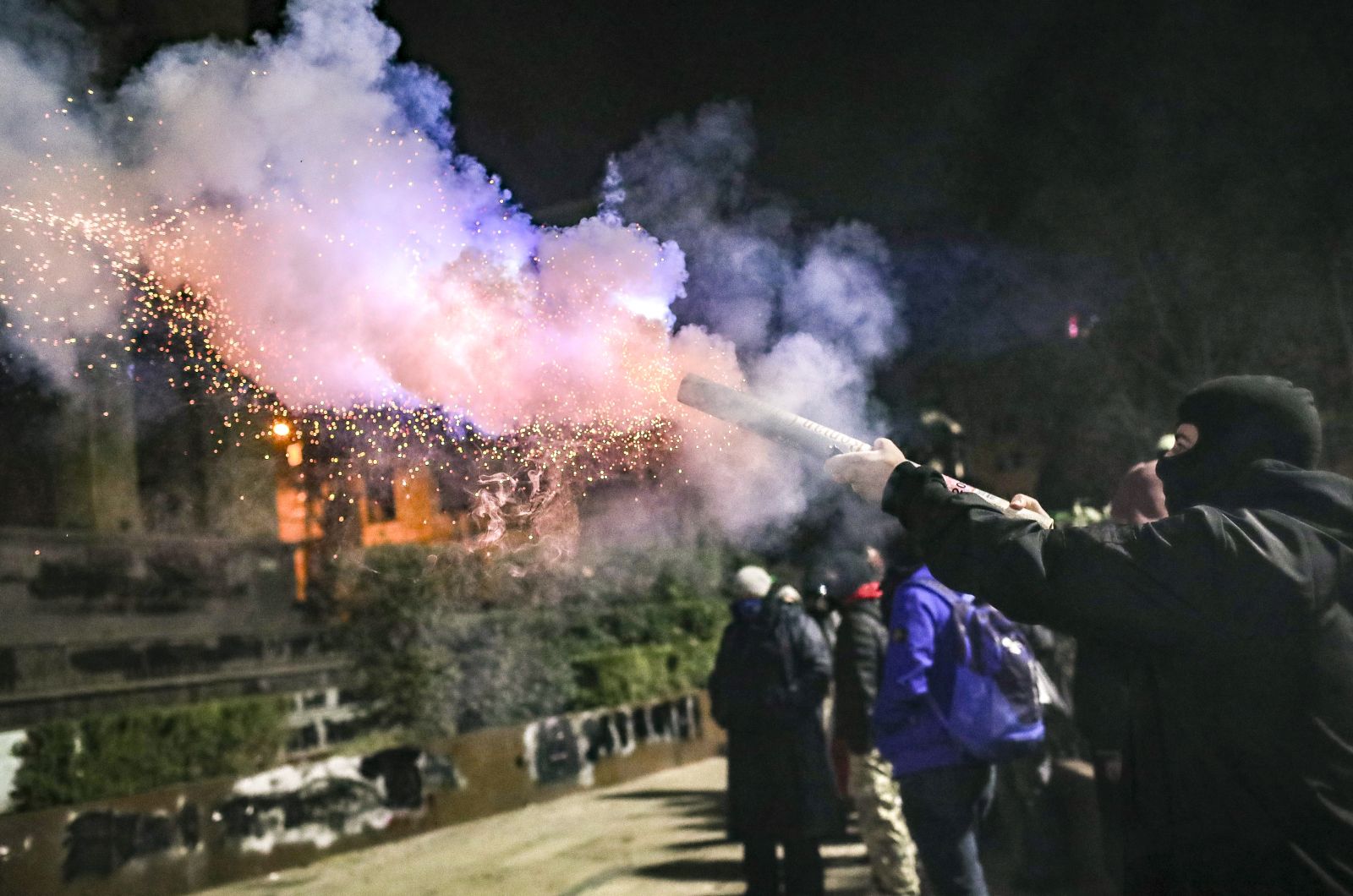 epa11761055 A supporter of the Georgian opposition launches fireworks during a protest in front of the Parliament building in Tbilisi, Georgia, 06 December 2024. Thousands of pro-EU activists continue their protests in the Georgian capital against the country's ruling party decision to suspend accession talks with the European Union (EU) until the end of 2028.  EPA/DAVID MDZINARISHVILI