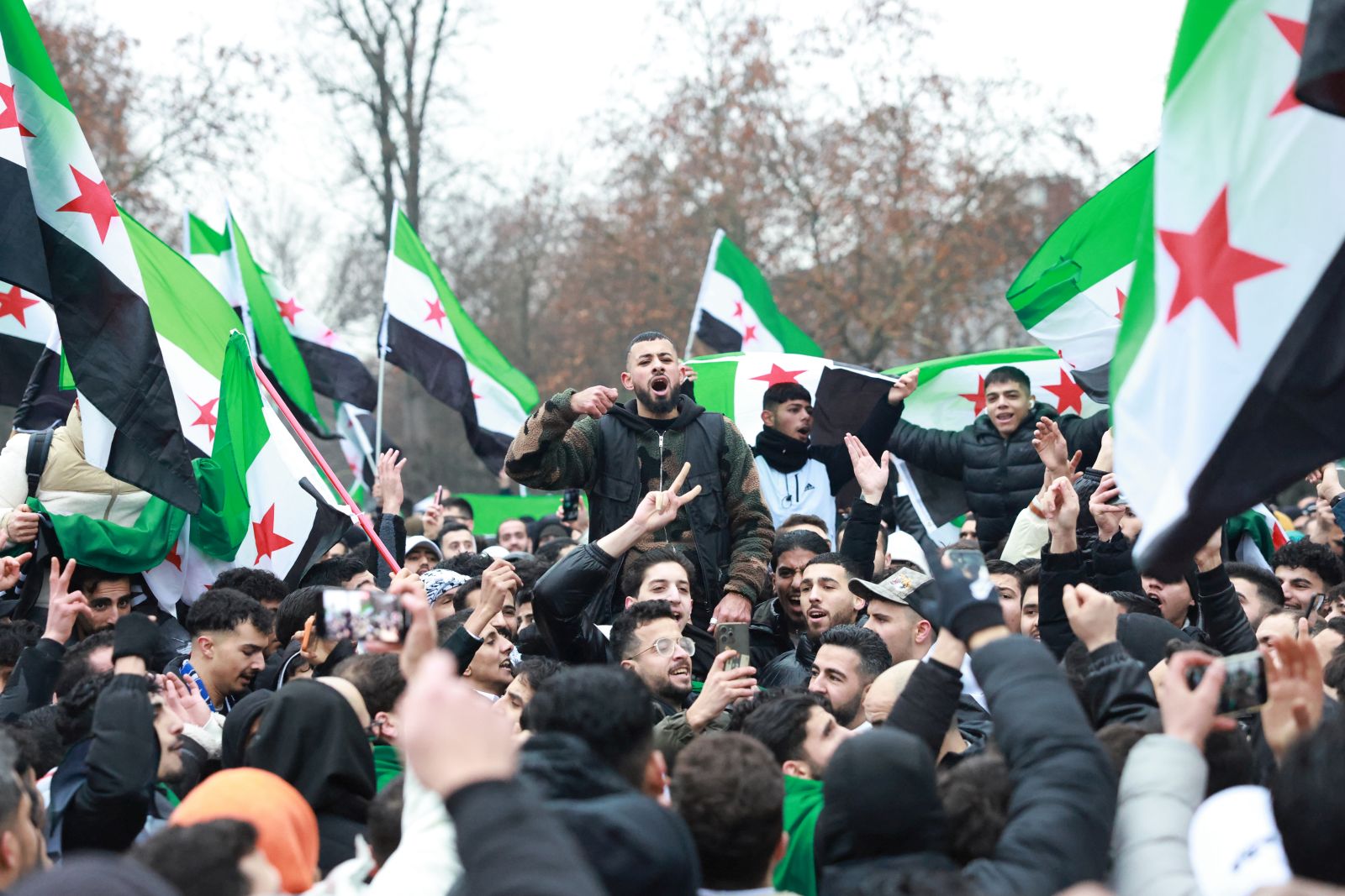 epa11764571 Supporters of the Syrian opposition residing in Germany celebrate the rebel take over of Damascus, in Berlin, Germany, 08 December 2024. Syrian rebels entered Damascus on 08 December 2024 and announced in a televised statement the 'Liberation of the city of Damascus and the overthrow of Bashar al-Assad,' as well as the release of all the prisoners. The rebels also urged the Syrian armed forces to leave Syrian public institutions, which will stay under the control of the outgoing Syrian prime minister until the official handover ceremony.  EPA/CLEMENS BILAN