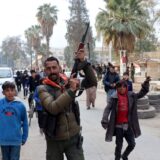 epa11764678 A fighter of the Syrian Democratic Forces (SDF) celebrates with residents after the SDF took control of the city of al-Hasakah, northeast Syria, 08 December 2024. SDF Commander-in-Chief Mazloum Abdi said in a statement on 08 December that 'Syria is living historic moments as we witness the fall of the oppressive regime in Damascus'. Syrian rebels led by Hayat Tahrir al-Sham (HTS) entered Damascus on 08 December 2024 and announced in a televised statement the 'Liberation of the city of Damascus and the overthrow of Bashar al-Assad', as well as the release of all the prisoners.  EPA/AHMED MARDNLI