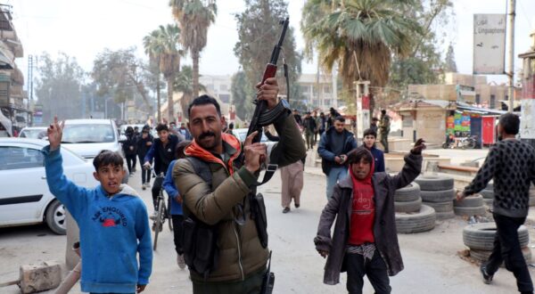 epa11764678 A fighter of the Syrian Democratic Forces (SDF) celebrates with residents after the SDF took control of the city of al-Hasakah, northeast Syria, 08 December 2024. SDF Commander-in-Chief Mazloum Abdi said in a statement on 08 December that 'Syria is living historic moments as we witness the fall of the oppressive regime in Damascus'. Syrian rebels led by Hayat Tahrir al-Sham (HTS) entered Damascus on 08 December 2024 and announced in a televised statement the 'Liberation of the city of Damascus and the overthrow of Bashar al-Assad', as well as the release of all the prisoners.  EPA/AHMED MARDNLI