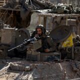 epa11774260 An Israeli soldier aboard an armoured vehicle mans a machine gun as they cross into the buffer zone between Israel and Syria, near the Druze village of Majdal Shams, in the Israeli-annexed Golan Heights, 13 December 2024. Israel's military said that paratroopers' forces, joined by other troops, are conducting 'defense activities' to prevent 'any threat' and are deployed in key positions within the buffer zone.  EPA/ATEF SAFADI