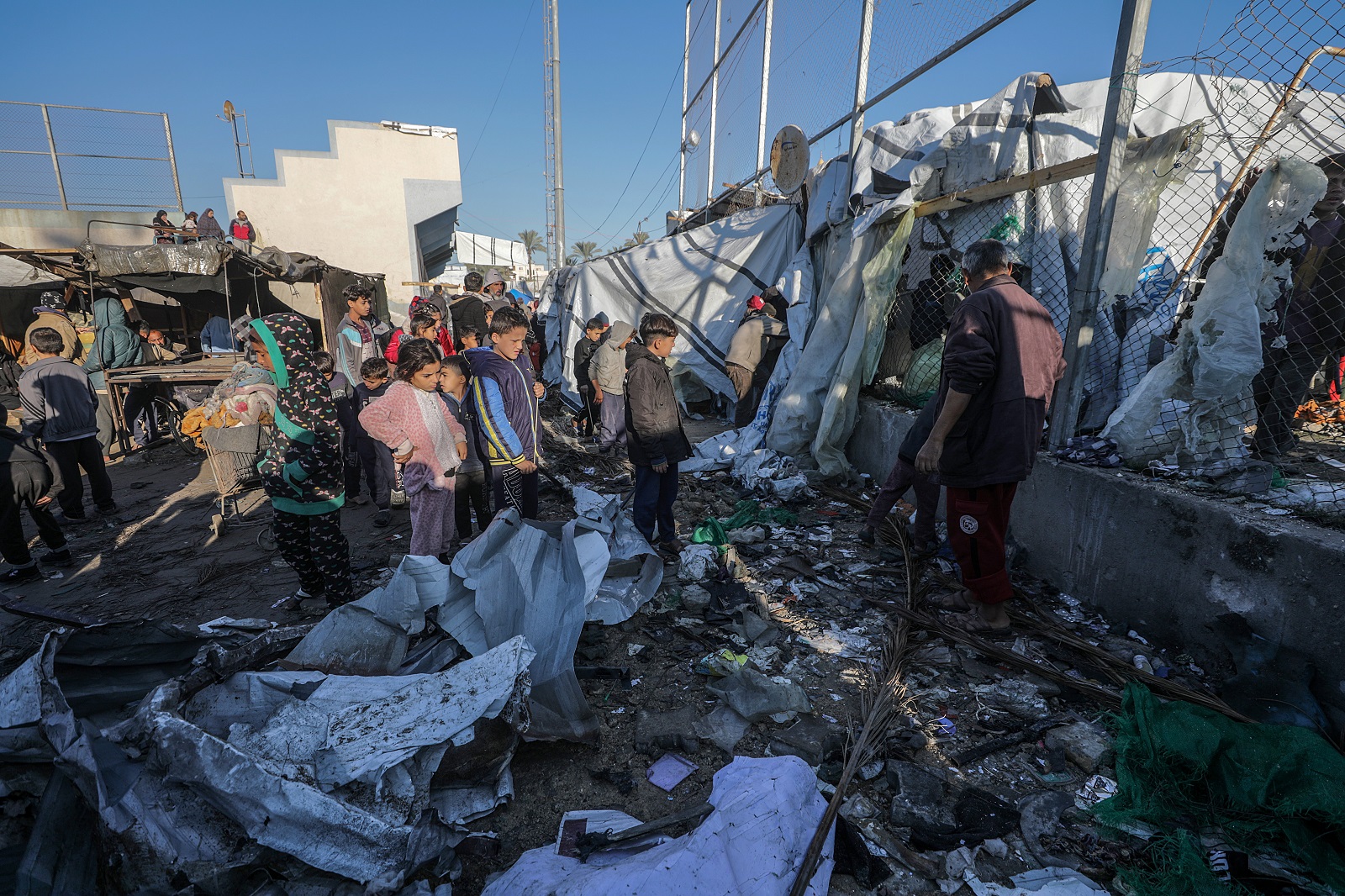 epa11778085 Internally displaced Palestinians inspect destroyed tents inside Al Dura stadium following an Israeli air strike in the west of Deir al-Balah town, central Gaza Strip, 15 December 2024. The Palestinian Ministry of Health in Gaza reported that at least 22 people were killed on December 14 during Israeli airstrikes on the central Gaza Strip. According to the UN, at least 1.9 million people (or nine in ten people) in the Gaza Strip are internally displaced, including people who have been repeatedly displaced. Since October 2023, only about 11 percent of the Gaza Strip has not been placed under Israeli-issued evacuation orders, the UN aid coordination office OCHA said.  EPA/MOHAMMED SABER