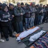 epa11780163 Palestinians pray in front of bodies of their relatives, after an Israeli air strike hit a UNRWA-run school, housing displaced people, in Khan Younis, southern Gaza Strip, 16 December 2024. According to medics at Nasser Hospital, at least 15 Palestinians were killed in the Israeli airstrike. More than 45,000 Palestinians and over 1,400 Israelis have been killed, according to the Palestinian Health Ministry and the Israeli Army, since Hamas militants launched an attack against Israel from the Gaza Strip on 07 October 2023, and the Israeli operations in Gaza and the West Bank which followed it.  EPA/HAITHAM IMAD