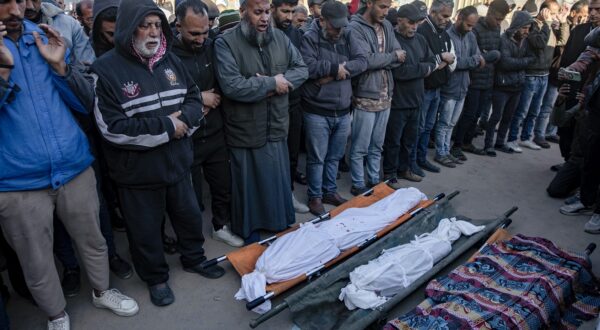 epa11780163 Palestinians pray in front of bodies of their relatives, after an Israeli air strike hit a UNRWA-run school, housing displaced people, in Khan Younis, southern Gaza Strip, 16 December 2024. According to medics at Nasser Hospital, at least 15 Palestinians were killed in the Israeli airstrike. More than 45,000 Palestinians and over 1,400 Israelis have been killed, according to the Palestinian Health Ministry and the Israeli Army, since Hamas militants launched an attack against Israel from the Gaza Strip on 07 October 2023, and the Israeli operations in Gaza and the West Bank which followed it.  EPA/HAITHAM IMAD