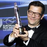 epa11763294 Nebojsa Slijepcevic, Croatian director of 'The Man Who Could Not Remain Silent', winner in the European Short Film Prix Vimeo category holds his trophy during the gala at the 37th European Film Awards at the Culture and Convention Center KKL in Lucerne, Switzerland, 07 December 2024.  EPA/PHILIPP SCHMIDLI