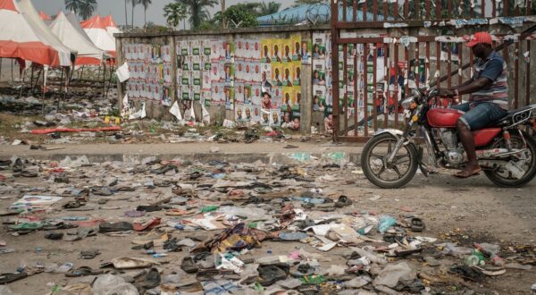 A biker rides next to shoes and items lying on the ground on February 13, 2019 in front of the main entrance of the Adokiye Amiesimaka Stadium where fifteen people were killed on February 12, 2019 in a stampede during an election campaign rally held by Nigerian President in Port Harcourt, Southern Nigeria. The deaths are the latest on the campaign trail before February 16 election, at which Buhari is seeking a second, four-year term of office.,Image: 413714786, License: Rights-managed, Restrictions: , Model Release: no, Credit line: Yasuyoshi CHIBA / AFP / Profimedia