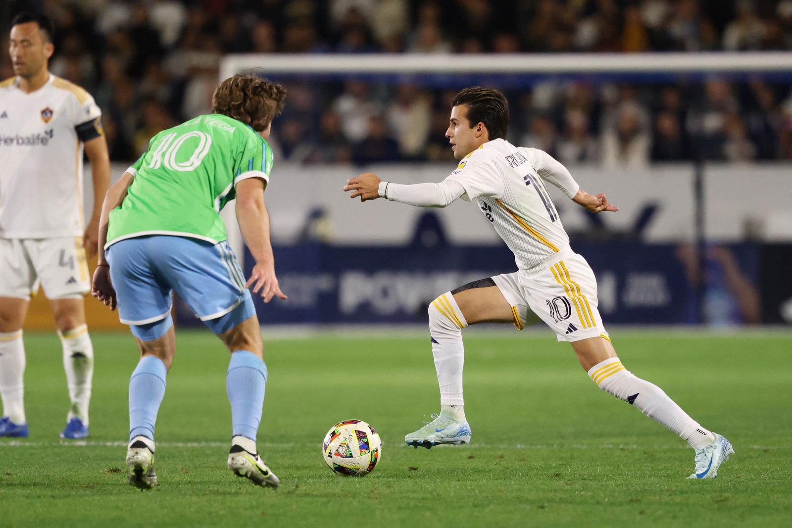 Nov 30, 2024; Carson, California, USA; LA Galaxy midfielder Riqui Puig (10) controls the ball against Seattle Sounders FC forward Pedro De La Vega (10) in the first half in the 2024 MLS Cup Western Conference Final match at Dignity Health Sports Park. Mandatory Credit: Kiyoshi Mio-Imagn Images Photo: Kiyoshi Mio/REUTERS