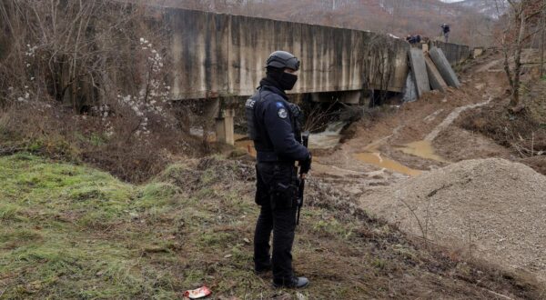 A Kosovo police officer patrols near the damaged canal supplying water to two coal-fired power plants that generate nearly all of the country's electricity, in Varage, near Zubin Potok, Kosovo December 1, 2024. REUTERS/Valdrin Xhemaj Photo: Valdrin Xhemaj/REUTERS