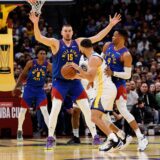 Dec 3, 2024; Denver, Colorado, USA; Golden State Warriors guard Stephen Curry (30) controls the ball under pressure from Denver Nuggets guard Russell Westbrook (4) and center Nikola Jokic (15) in the fourth quarter at Ball Arena. Mandatory Credit: Isaiah J. Downing-Imagn Images Photo: Isaiah J. Downing/REUTERS