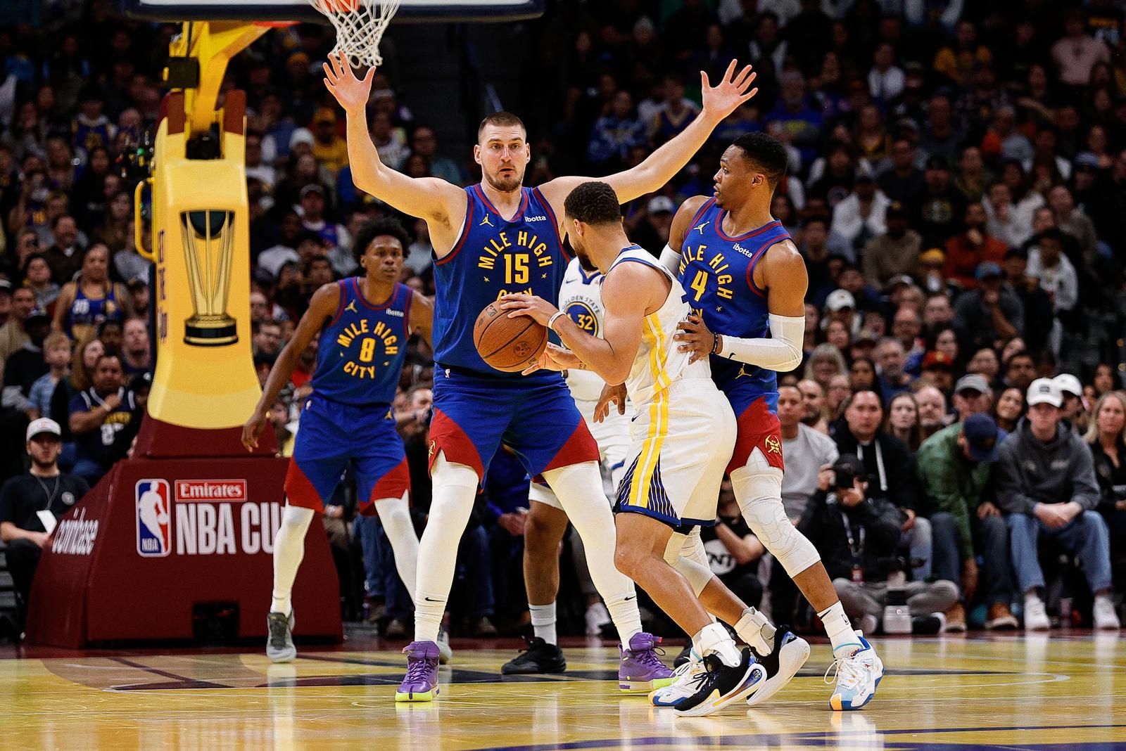 Dec 3, 2024; Denver, Colorado, USA; Golden State Warriors guard Stephen Curry (30) controls the ball under pressure from Denver Nuggets guard Russell Westbrook (4) and center Nikola Jokic (15) in the fourth quarter at Ball Arena. Mandatory Credit: Isaiah J. Downing-Imagn Images Photo: Isaiah J. Downing/REUTERS