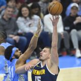 Dec 5, 2024; Cleveland, Ohio, USA; Denver Nuggets center Nikola Jokic (15) shoots beside Cleveland Cavaliers center Jarrett Allen (31) in the first quarter at Rocket Mortgage FieldHouse. Mandatory Credit: David Richard-Imagn Images Photo: David Richard/REUTERS