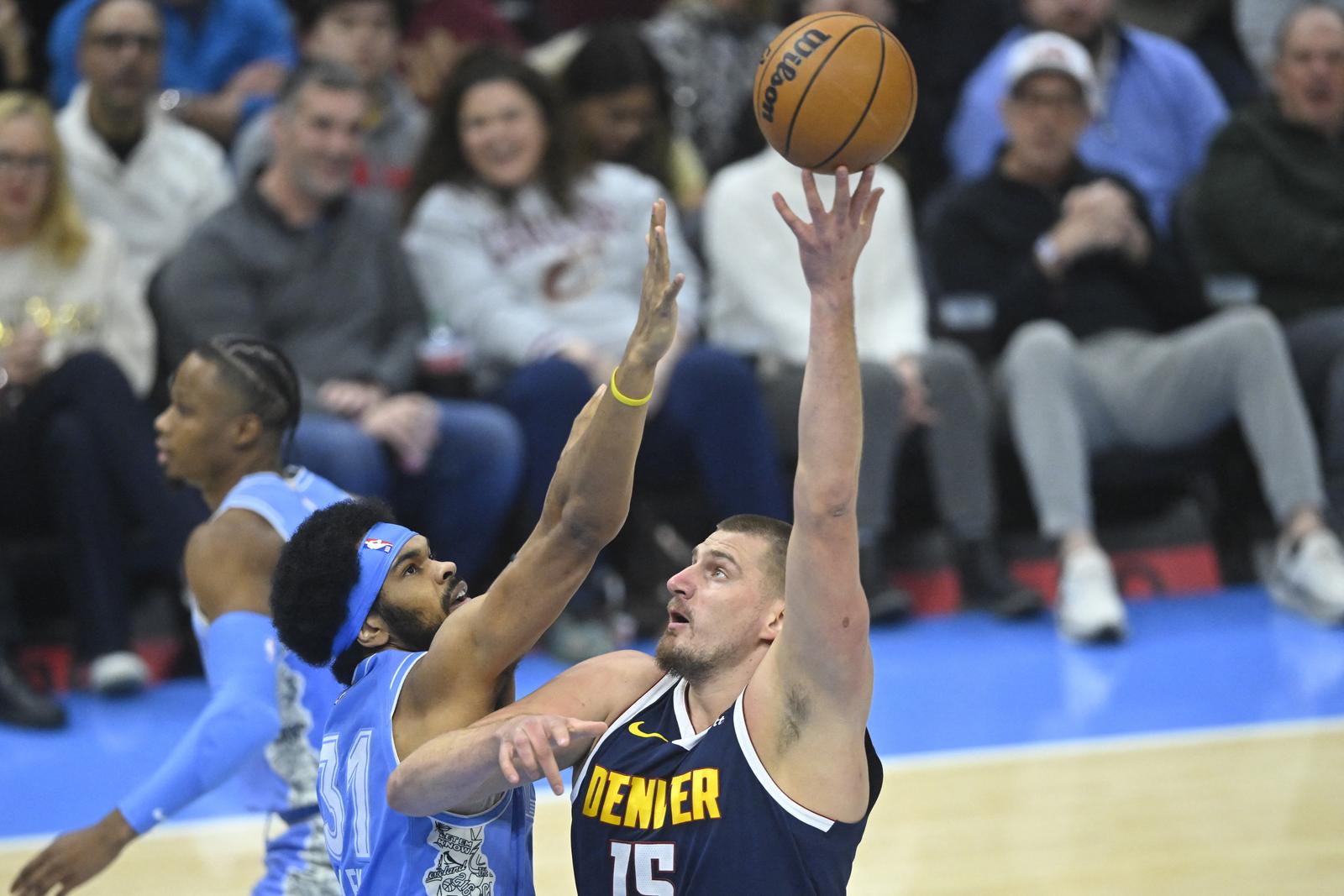 Dec 5, 2024; Cleveland, Ohio, USA; Denver Nuggets center Nikola Jokic (15) shoots beside Cleveland Cavaliers center Jarrett Allen (31) in the first quarter at Rocket Mortgage FieldHouse. Mandatory Credit: David Richard-Imagn Images Photo: David Richard/REUTERS