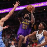 Dec 6, 2024; Atlanta, Georgia, USA; Los Angeles Lakers forward LeBron James (23) shoots past Atlanta Hawks guard Bogdan Bogdanovic (13) and forward De'Andre Hunter (12) in the second quarter at State Farm Arena. Mandatory Credit: Brett Davis-Imagn Images Photo: Brett Davis/REUTERS