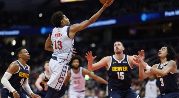 Dec 7, 2024; Washington, District of Columbia, USA; Washington Wizards guard Jordan Poole (13) shoots the ball as Denver Nuggets center Nikola Jokic (15) looks on in the third quarter at Capital One Arena. Mandatory Credit: Geoff Burke-Imagn Images Photo: Geoff Burke/REUTERS