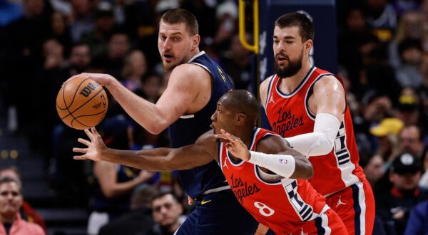 Dec 13, 2024; Denver, Colorado, USA; Los Angeles Clippers guard Kris Dunn (8) attempts to steal the ball away from Denver Nuggets center Nikola Jokic (15) as center Ivica Zubac (40) defends in the second quarter at Ball Arena. Mandatory Credit: Isaiah J. Downing-Imagn Images Photo: Isaiah J. Downing/REUTERS