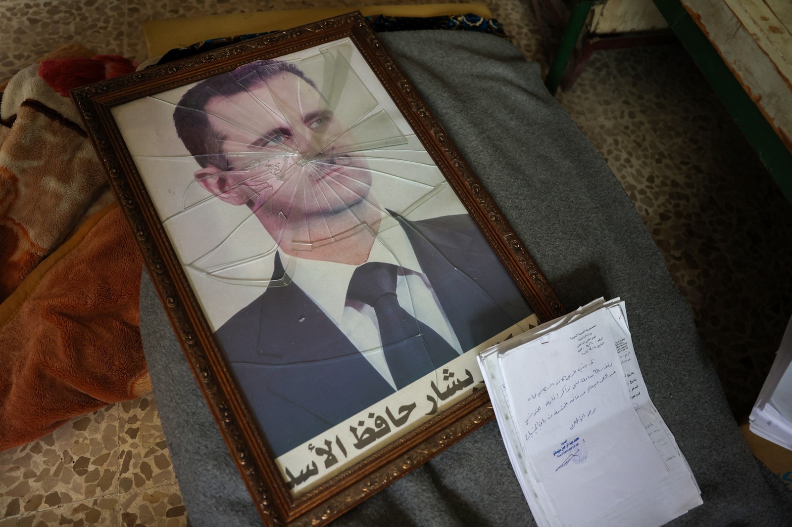 A portrait of Syrian President Bashar al-Assad is pictured with its frame broken, in a Syrian regime's Political Security Branch facility on the outskirts of the central city of Hama, following the capture of the area by anti-government forces, on December 7, 2024. Syria's embattled government said on December 7 it was setting up a ring of steel around Damascus, state media reported, as rebels on a lightning advance said they were bearing down on the city. The leader of Hayat Tahrir al-Sham (HTS), the Islamist group which has headed the assault, told fighters to prepare to take Damascus, just over a week into a renewed offensive in the long dormant conflict.,Image: 944142018, License: Rights-managed, Restrictions: , Model Release: no, Credit line: OMAR HAJ KADOUR / AFP / Profimedia