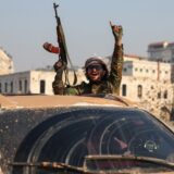 An anti-government fighter gestures from inside a vehicle patrolling the streets of Hama after they captured the central Syrian city, on December 6, 2024. Rebel forces pressing a lightning offensive in Syria aim to overthrow President Bashar al-Assad's rule, their Islamist leader said in an interview published on December 6. In little over a week, the offensive has seen Syria's second city Aleppo and strategically located Hama fall from Assad's control for the first time since the civil war began in 2011.,Image: 943721607, License: Rights-managed, Restrictions: , Model Release: no, Credit line: OMAR HAJ KADOUR / AFP / Profimedia