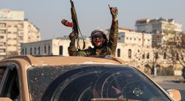 An anti-government fighter gestures from inside a vehicle patrolling the streets of Hama after they captured the central Syrian city, on December 6, 2024. Rebel forces pressing a lightning offensive in Syria aim to overthrow President Bashar al-Assad's rule, their Islamist leader said in an interview published on December 6. In little over a week, the offensive has seen Syria's second city Aleppo and strategically located Hama fall from Assad's control for the first time since the civil war began in 2011.,Image: 943721607, License: Rights-managed, Restrictions: , Model Release: no, Credit line: OMAR HAJ KADOUR / AFP / Profimedia