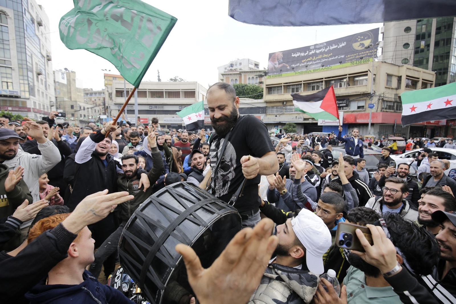 Syrian and Lebanese people celebrate the fall of the Syrian regime on December 8, 2024, in the northern Lebanese city of Tripoli, after the Syrian capital Damascus fell into the hands of anti-government fighters. Islamist-led rebels declared that they have taken Damascus in a lightning offensive on December 8, sending President Bashar al-Assad fleeing and ending five decades of Baath rule in Syria.,Image: 944357292, License: Rights-managed, Restrictions: , Model Release: no, Credit line: Ibrahim Chalhoub / AFP / Profimedia