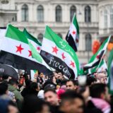 Members of the Syrian community wave Syrian flags on December 8, 2024 in Vienna, Austria and celebrate the end of Syrian dictator Bashar al-Assad's rule after rebel fighters took control of the Syrian capital Damascus overnight. Islamist-led rebels toppled Syria's longtime ruler Bashar al-Assad in a lightning offensive that a UN envoy called 