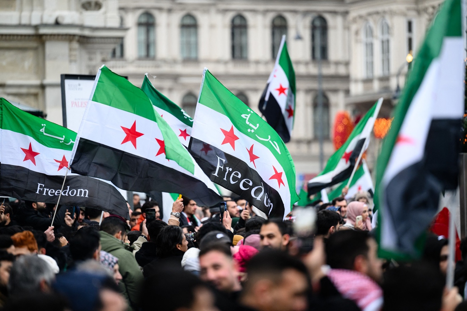 Members of the Syrian community wave Syrian flags on December 8, 2024 in Vienna, Austria and celebrate the end of Syrian dictator Bashar al-Assad's rule after rebel fighters took control of the Syrian capital Damascus overnight. Islamist-led rebels toppled Syria's longtime ruler Bashar al-Assad in a lightning offensive that a UN envoy called "a watershed moment" for the nation marred by civil war.,Image: 944395535, License: Rights-managed, Restrictions: Austria OUT / SOUTH TYROL OUT, Model Release: no, Credit line: MAX SLOVENCIK / AFP / Profimedia