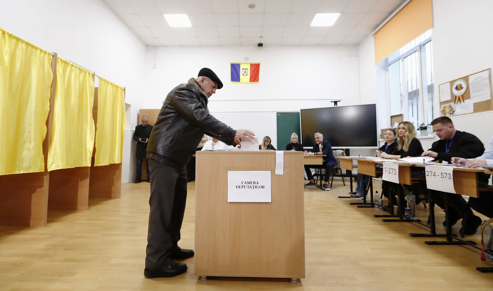 epaselect epa11751057 An elderly man casts his ballot at a polling station in Mogosoaia, Romania, 01 December 2024. Approximately 18 million Romanian citizens are expected at the polling stations this weekend for choosing the bicameral parliament members, according to the Permanent Electoral Authority (AEP), of which 989,230 people can express their intention abroad.  EPA/ROBERT GHEMENT