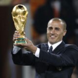 Italian footballer Fabio Cannavaro, captain of the 2006 World Cup winning team presents the world cup trophy prior to the 2010 FIFA football World Cup final between the Netherlands and Spain on July 11, 2010 at Soccer City stadium in Soweto, suburban Johannesburg. NO PUSH TO MOBILE / MOBILE USE SOLELY WITHIN EDITORIAL ARTICLE -,Image: 76785656, License: Rights-managed, Restrictions: NO PUSH TO MOBILE / MOBILE USE SOLELY WITHIN EDITORIAL ARTICLE, Model Release: no, Credit line: THOMAS COEX / AFP / Profimedia