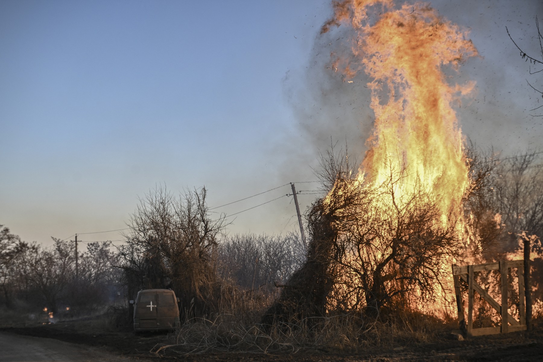 Trees burn next to a Ukrainian military vehicle, after white phosphorus munitions exploded in the air, at the village of Chasiv Yar near Bakhmut, on March 14, 2023, amid the Russian invasion of Ukraine.,Image: 762771122, License: Rights-managed, Restrictions: , Model Release: no, Credit line: Aris Messinis / AFP / Profimedia