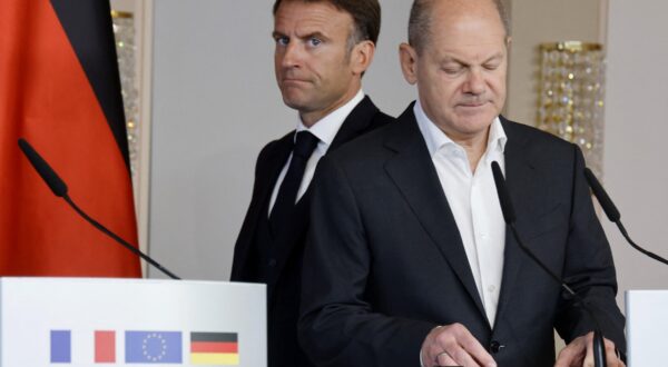 French President Emmanuel Macron (L) walks behind German Chancellor Olaf Scholz (R) as they arrive to address a joint press conference in Hamburg, northern Germany, on October 10, 2023, on the second day of two-day German-French government consultations.,Image: 812528166, License: Rights-managed, Restrictions: , Model Release: no, Credit line: Ludovic MARIN / AFP / Profimedia