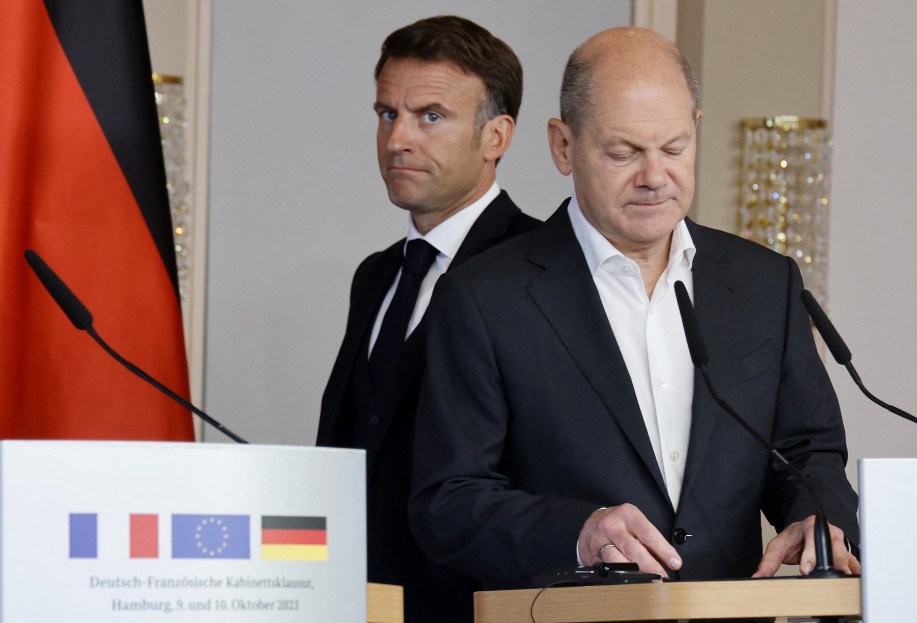 French President Emmanuel Macron (L) walks behind German Chancellor Olaf Scholz (R) as they arrive to address a joint press conference in Hamburg, northern Germany, on October 10, 2023, on the second day of two-day German-French government consultations.,Image: 812528166, License: Rights-managed, Restrictions: , Model Release: no, Credit line: Ludovic MARIN / AFP / Profimedia