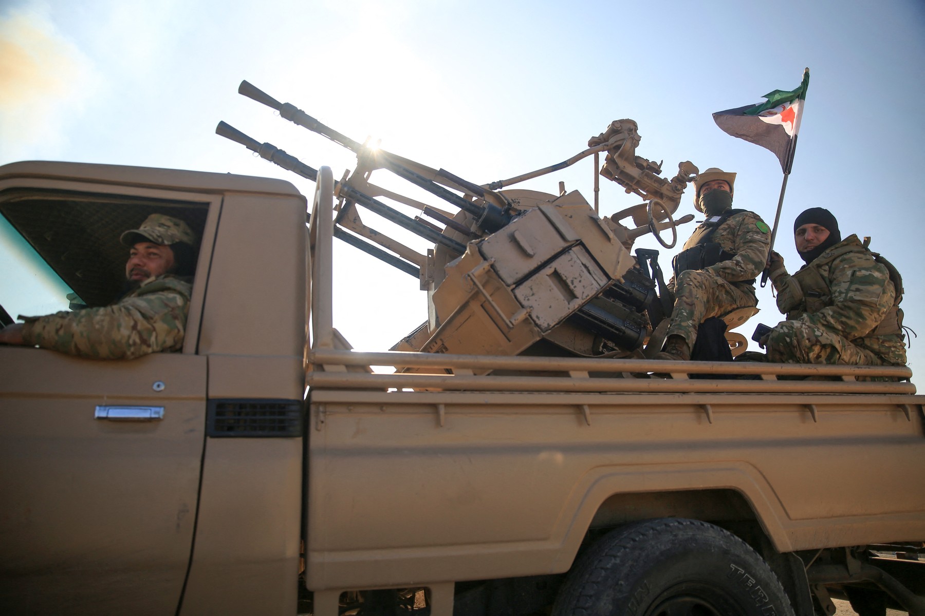 Anti-government fighters ride military vehicles as they drive along a road in the eastern part of Aleppo province on December 1, 2024. Syria's second-largest city Aleppo has fallen from government control for the first time since the country's conflict began more than a decade ago, a war monitor said on December 1, after a surprise advance by rebels.,Image: 941575925, License: Rights-managed, Restrictions: , Model Release: no, Credit line: Aref TAMMAWI / AFP / Profimedia