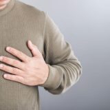 A man touches his left chest, indicating pain that may signal heart or cardiovascular issues. Image emphasizes the importance of early detection and awareness in preventing heart-related health risks,Image: 942058392, License: Royalty-free, Restrictions: , Model Release: no, Credit line: Phanuwat Nandee / Alamy / Alamy / Profimedia